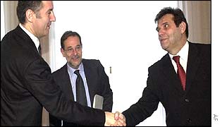 Montenegrin President Milo Djukanovic shakes hands with Yugoslav President Vojislav Kostunica while Javier Solana looks on
