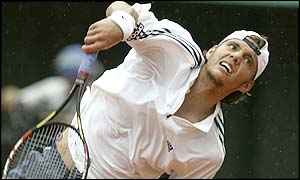 Paul-Henri Mathieu serves up some tough shots in his match against Andre Agassi