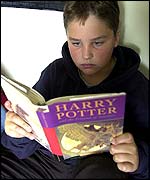 Boy reading Harry Potter book