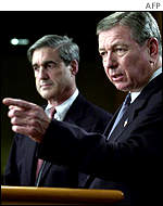 US Attorney General John Ashcroft answers reporters questions after he highlights criminal charges filed against former WorldCom executives.