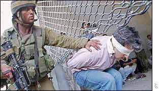 Israeli soldier arrests Palestinian