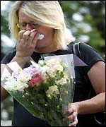 A woman attending the service breaks down in tears