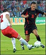 Poland's Arkadiusz Glowacki (left) tackles Belgian Walter Baseggio 