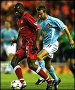 Middlesbrough defender Ugo Ehiogu takes the ball away from Ipswich striker Marcus Stewart