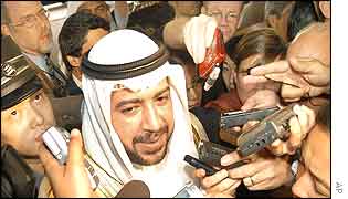 Acting oil minister for Kuwait surrounded by journalists