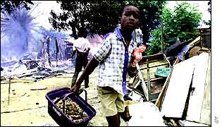 A child carrying his toys fleeing the fighting 