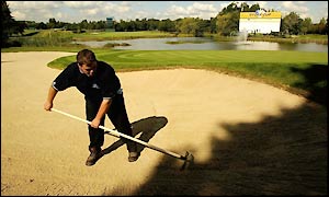 A groundsman prepares a bunker