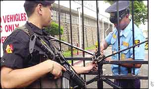A security guards checks the lock on the US embassy in Manila on Tuesday