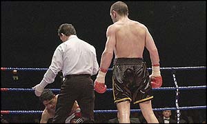 Harrison watches as the referee counts Chacon up in the 12th 