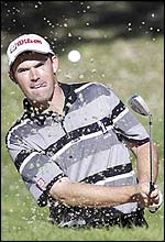 Harrington chips out of a bunker on the 6th