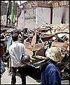 Residents and foreigners survey the damage