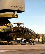 An Apache helicopter offloaded from a military transport