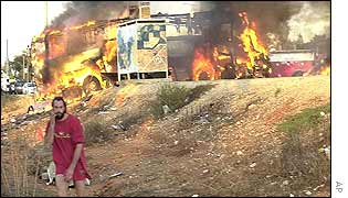 A man walks away from an October bus bomb