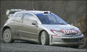 Marcus Gronholm's Peugeot holds a lead of nearly a minute, ahead of Subaru's Petter Solberg and the Ford of Markko Martin