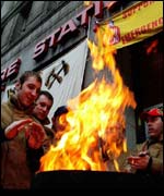 Firefighters keep warm at a picket fire