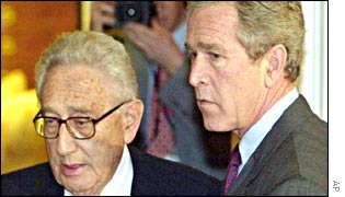 Henry Kissinger (L) and George W Bush