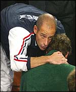 French captain Guy Forget (left) comforts Paul-Henri Mathieu 