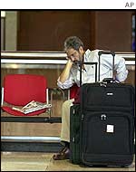 A passenger waits at the Simon Bolivar airport in Caracas
