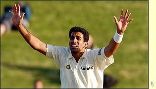 Khan celebrates as Hart is bowled lbw for six runs in the day's penultimate over