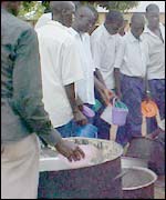 Students queue up for food in a Lira camp