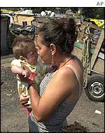 Brazilian woman with her child in a shanty town