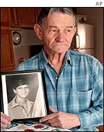 Vern Fuling with a picture of his son William, murdered in 1985