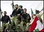 Hezbollah guerillas enter a town on a tank 
