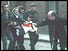 Boy carried to safety as priest waves surrender