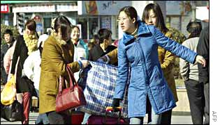 Travellers struggle with their baggage at Beijing railway station