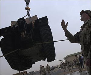 Soldier from US 82nd Airborne Division helps unload equipment used to rebuild airstrips 