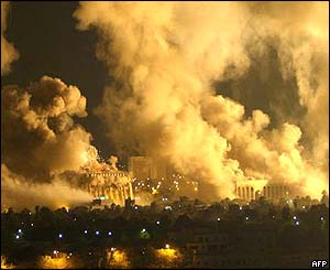 Smoke rises from two Iraqi Government buildings hit by coalition forces