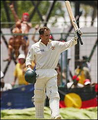 Langer salutes the crowd after reaching his hundred