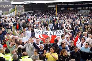 Swansea supporters mass on the pitch. The Vetch had been a sell-out and the fans will party long into the night.
