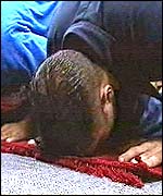 Crewman Naveed Muhammed prays on board the USS Abraham Lincoln