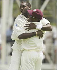 West Indies bowler Jermaine Lawson celebrates with Brian Lara after claiming the wicket of Matthew Hayden 