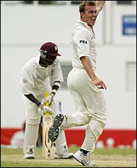Australia's Brett Lee celebrates claiming the wicket of Vasbert Drakes 