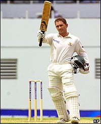 Justin Langer salutes the Australian dressing room after reaching his hundred
