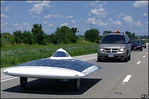 Solar car speeds ahead of regular car on highway