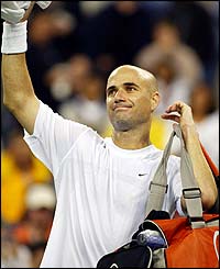 Andre Agassi salutes the crowd after his fourth round win