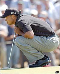Tiger Woods lines up a putt