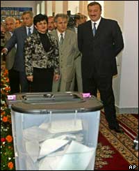 Ilham Aliyev and others look at ballot box