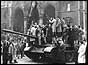 Demonstrators climbing on to tank