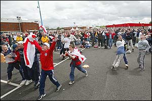 Fans pack the Old Trafford car park to watch England play Denmark in the 2002 football World Cup 
