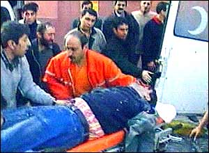 Injured man being carried away on stretcher