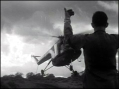 Man guides in helicopter during relief operation