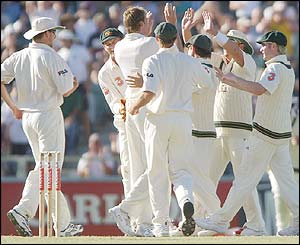 Australia's players congratulate Glenn McGrath on the wicket on Imran Farhat