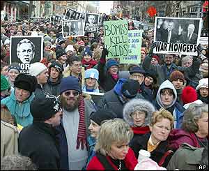 Protesters hold anti-Bush signs along the route of US President George W Bush's second term inauguration parade 