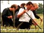 Photo of police searching fields near the Russell family home