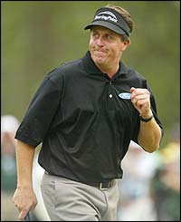 Phil Mickelson holes a third straight birdie at the 14th