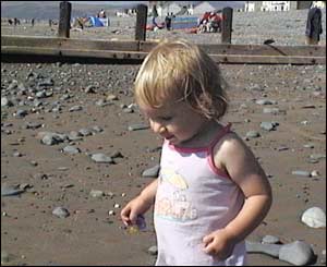 Emma Davies' daughter Aimee on Borth Beach enjoying the sunshine and waves